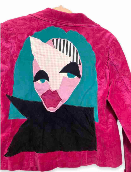 a pink jacket with a picture of a woman's face on it.