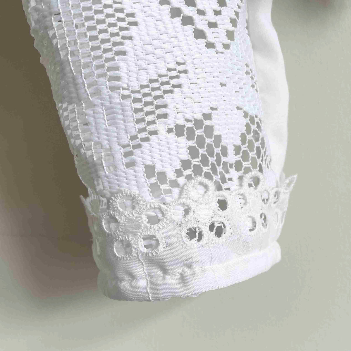 a close up of a white shirt on a hanger.