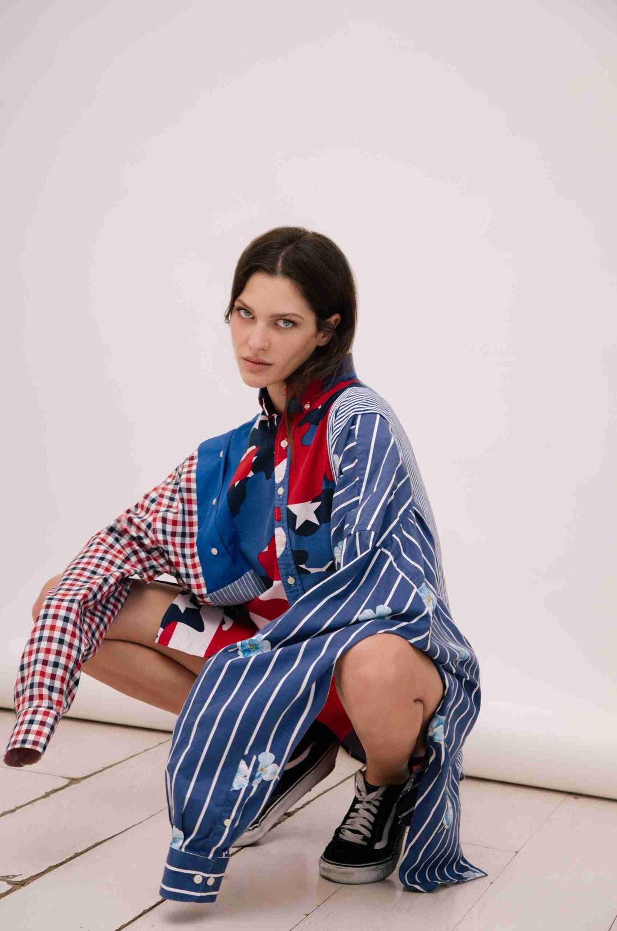 a woman sitting on the floor in a dress.