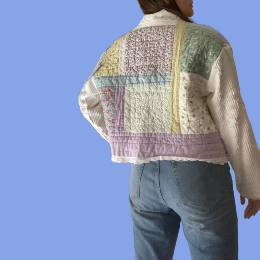 The back of a woman wearing a quilted jacket.