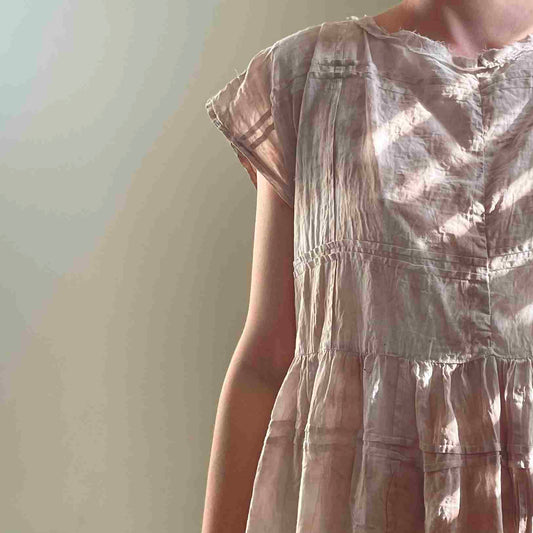 a woman in a dress is holding a cell phone.