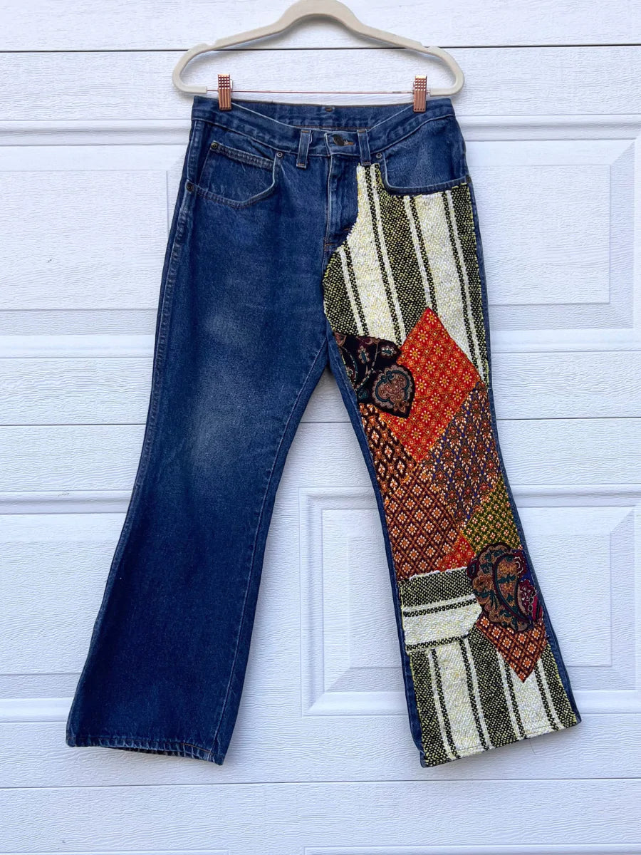 a pair of jeans hanging on a door.