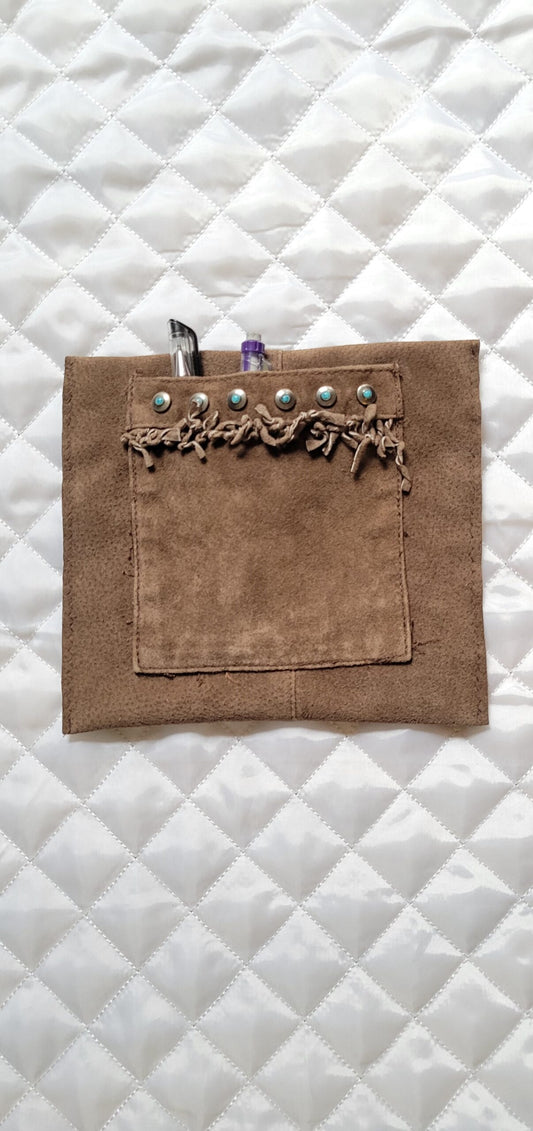 A brown leather pouch with a pen in it.