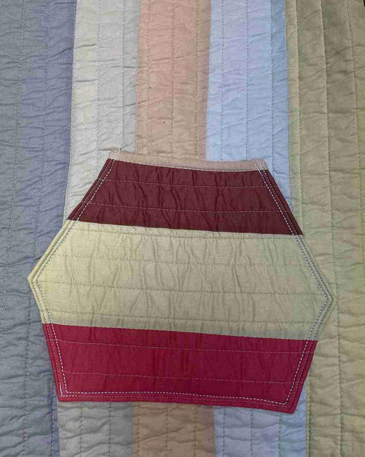 a close up of a quilt on a bed.