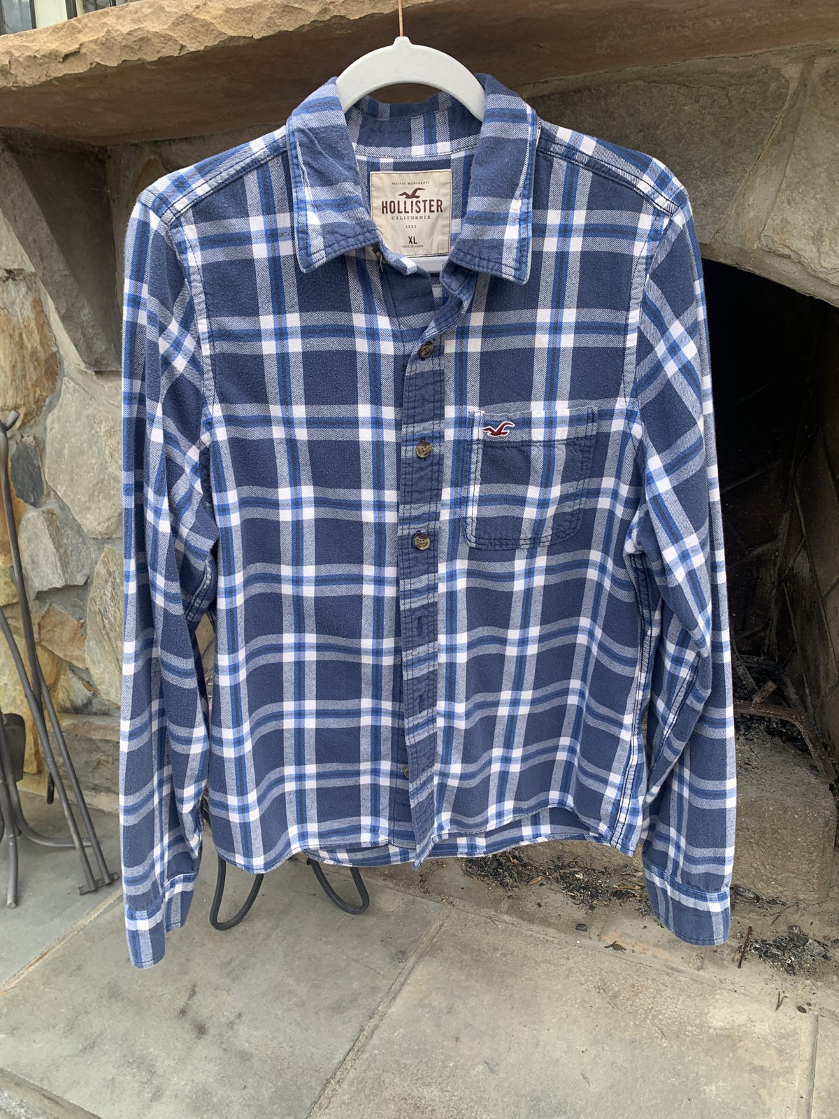 A Pinball Wizard Rock Band Music flannel shirt hanging on a rack.