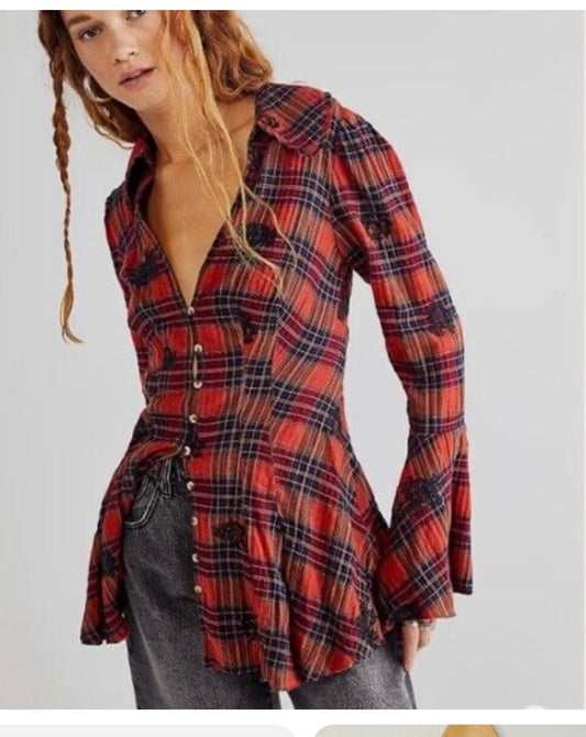 a woman is wearing a plaid shirt and jeans.