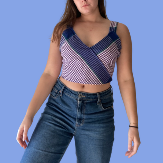 A woman wearing jeans and a plaid top.