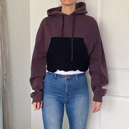 A woman wearing jeans and a hoodie.