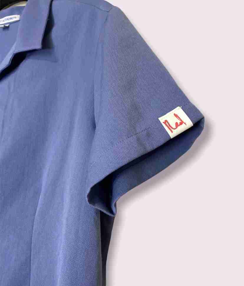 a blue shirt with a label on it.