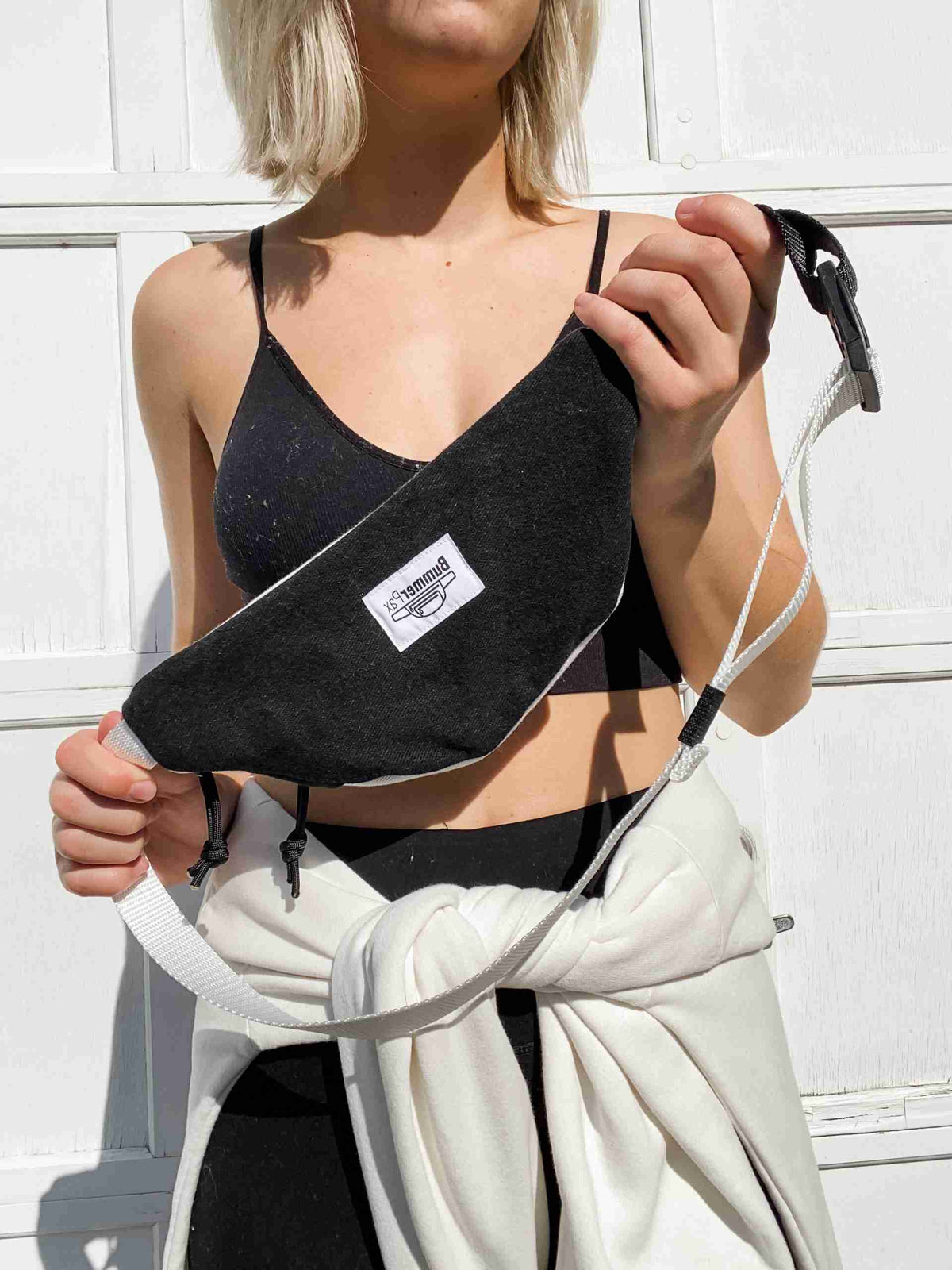 a woman holding a white object in her right hand.
