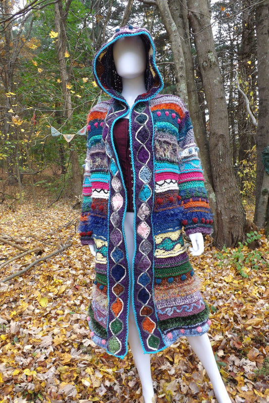 A long crochet coat with elf hood and medallion border and lots of textures.