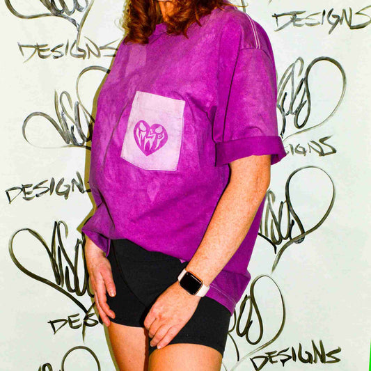 a woman wearing a purple shirt and black shorts.