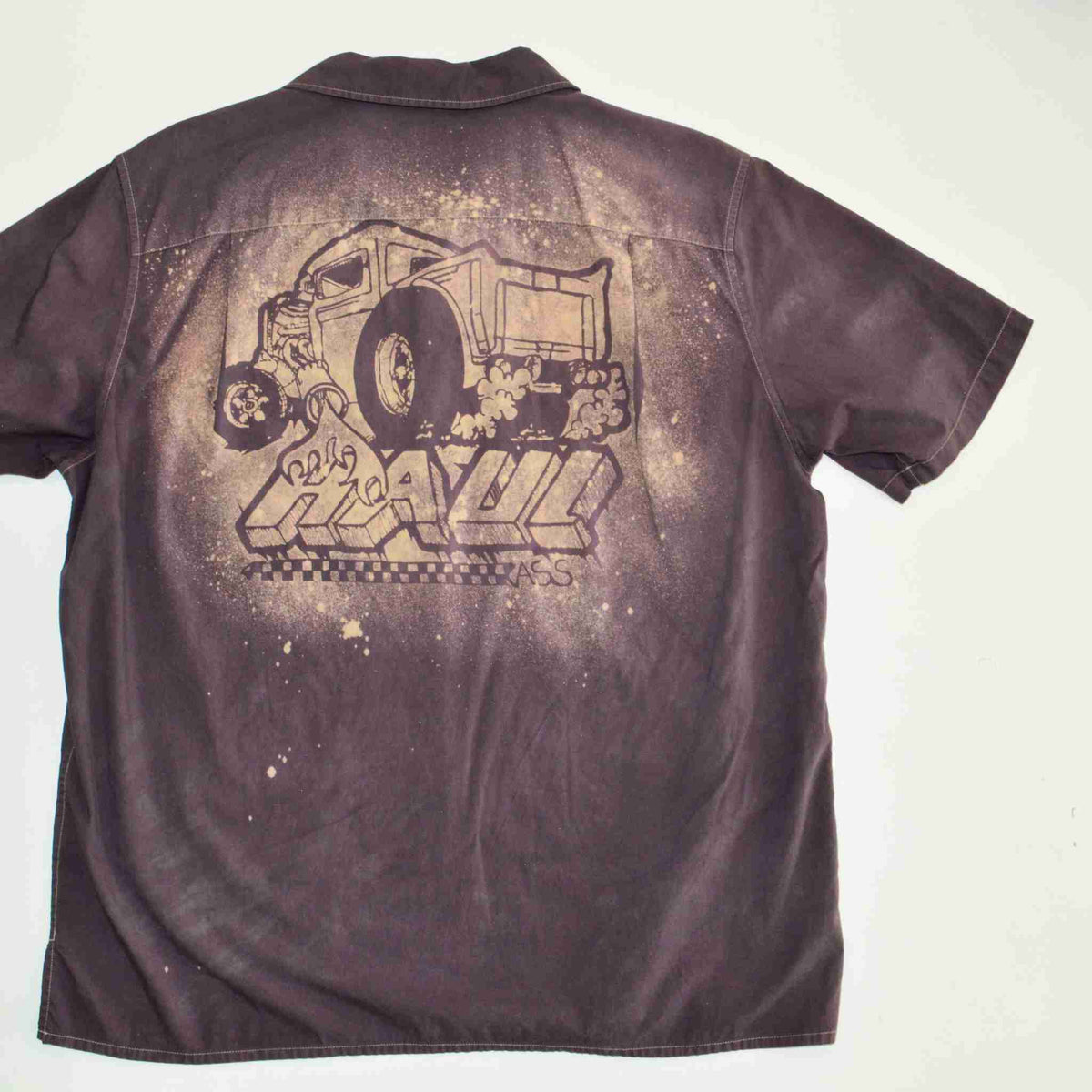 a brown shirt with a drawing of a train on it.