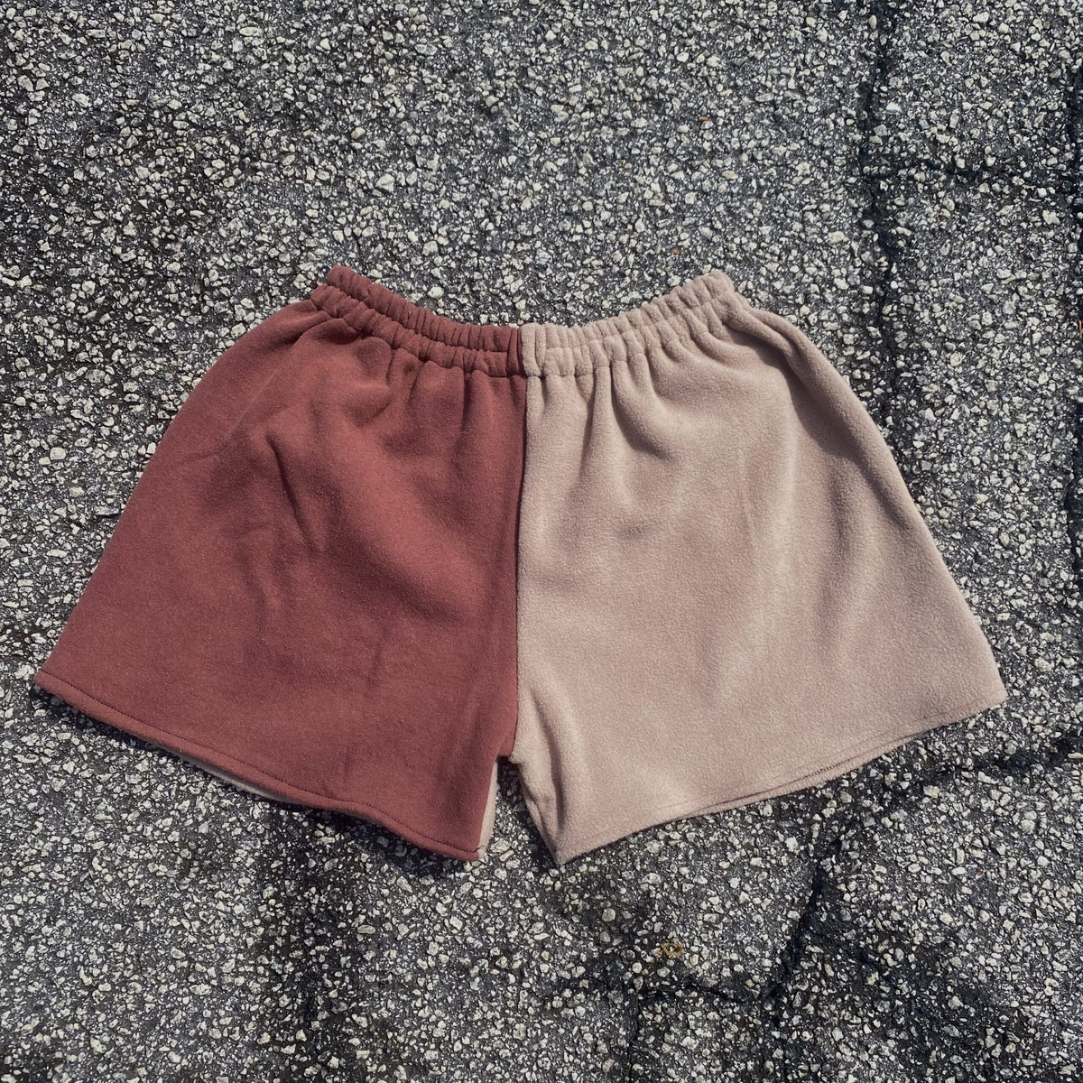 a pair of shorts sitting on top of a bed.