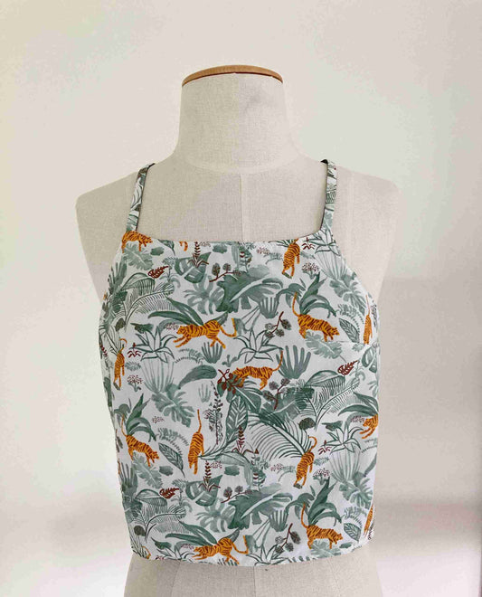 a white mannequin with a green and orange top on it.