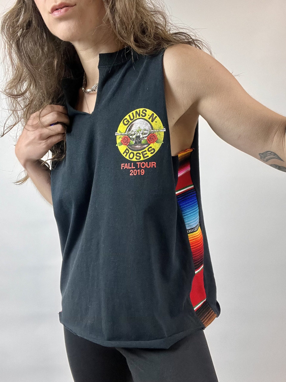 a woman with long hair wearing a black tank top.