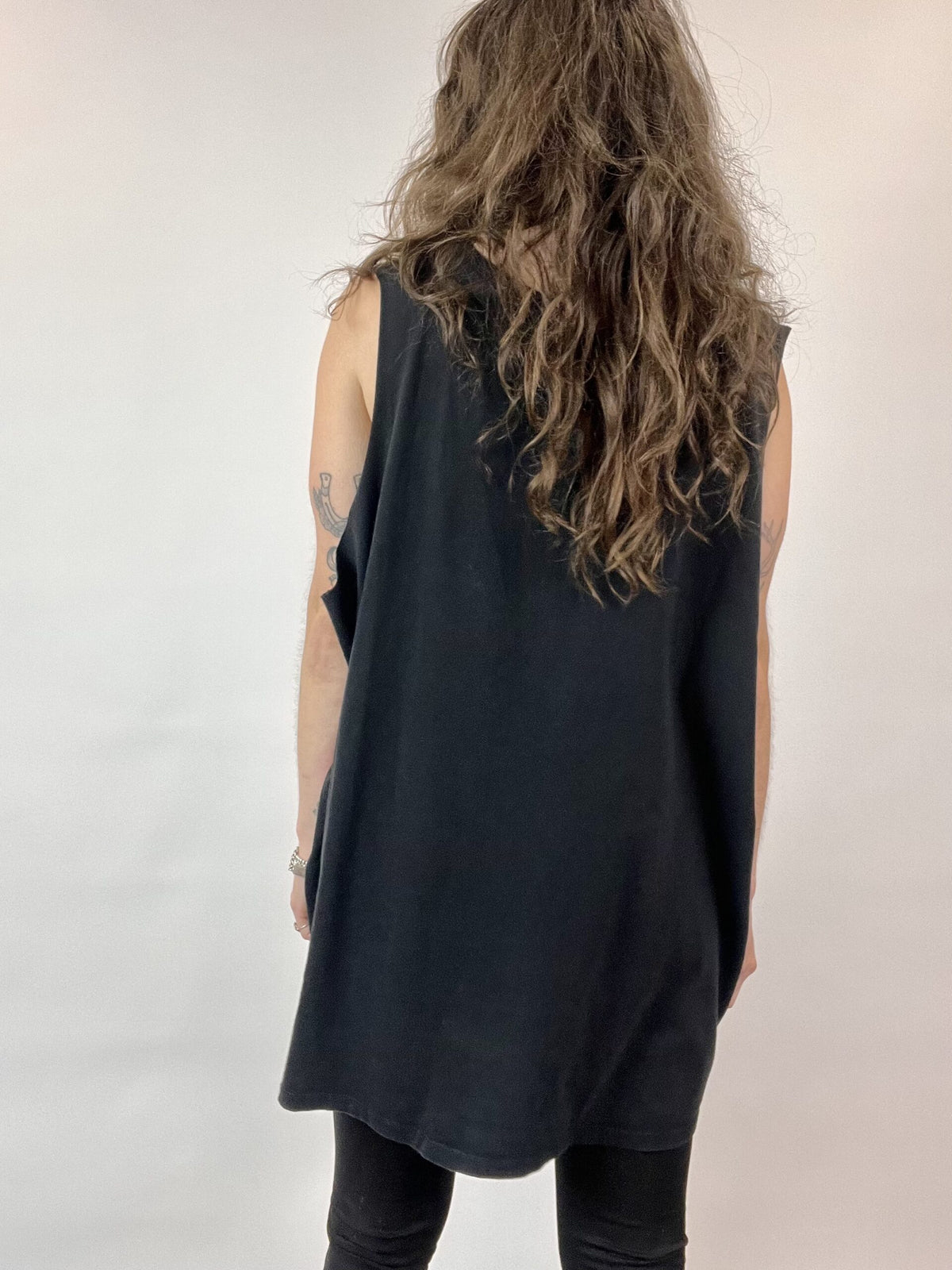 a woman with long hair wearing a black top.