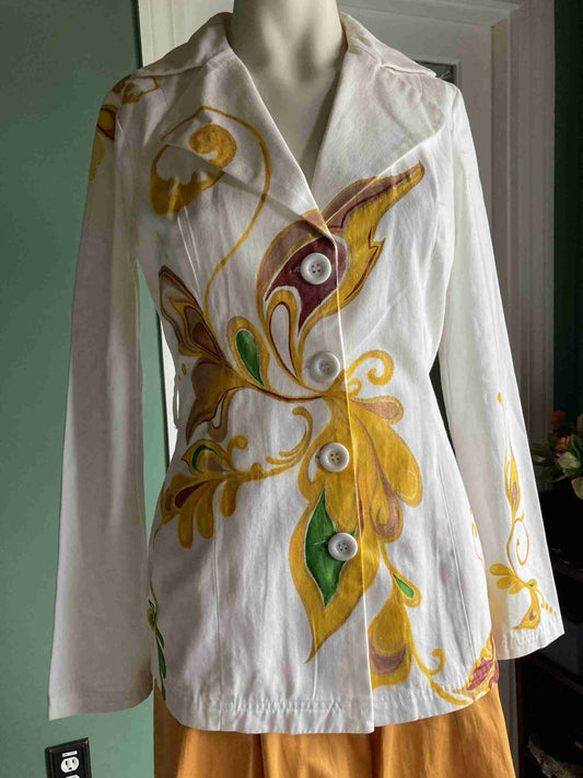 a white shirt with yellow and green designs on it.