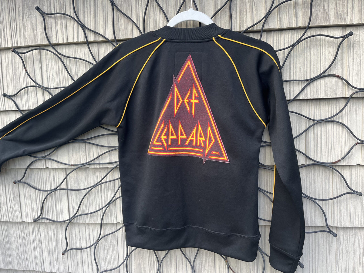 A black sweatshirt with an orange triangle on it.