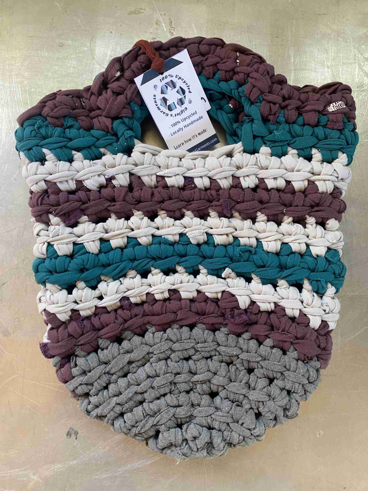 a multicolored basket with a tag on it.