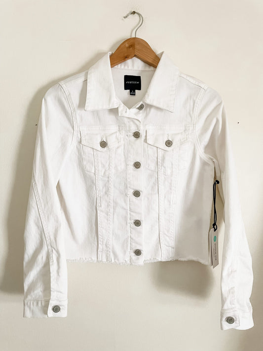 A white denim jacket hanging on a hanger.