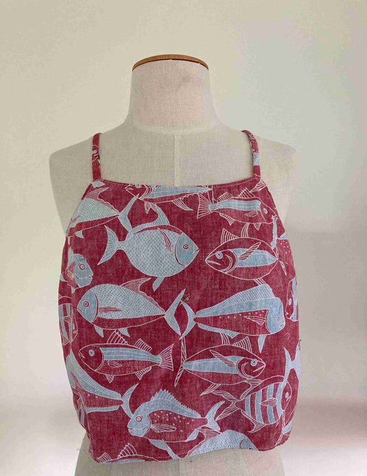 a mannequin wearing a red and white top with fish on it.