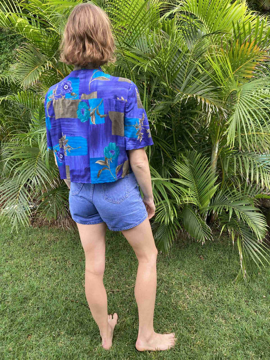 a person standing in front of a bush.