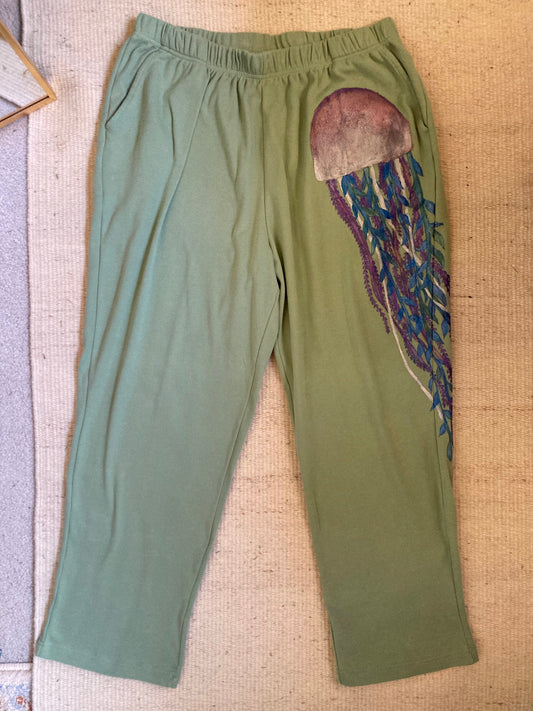 A pair of green pants with a jellyfish on them.