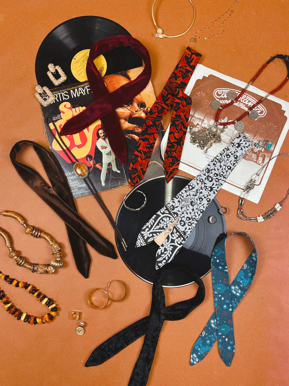 a table topped with lots of different types of jewelry.