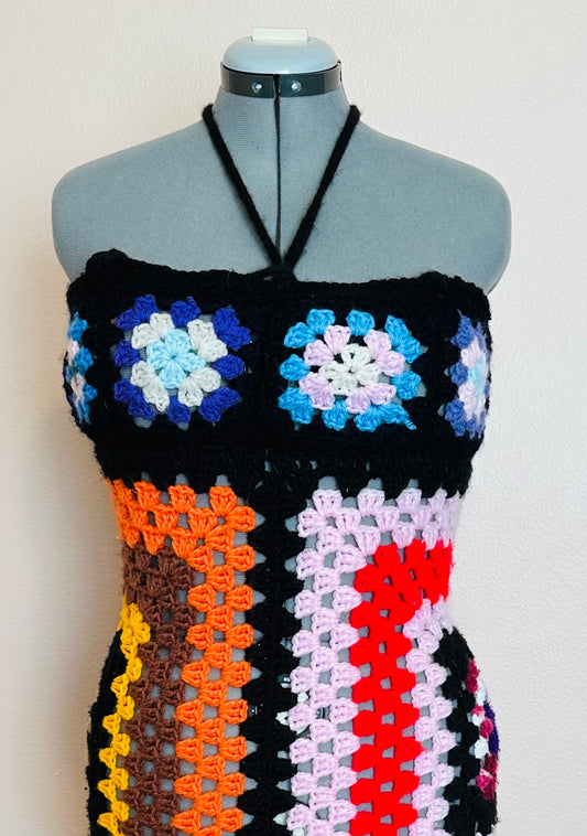 A crocheted top on a mannequin dummy.