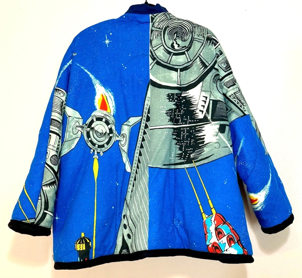 A blue jacket with a spaceship on it.