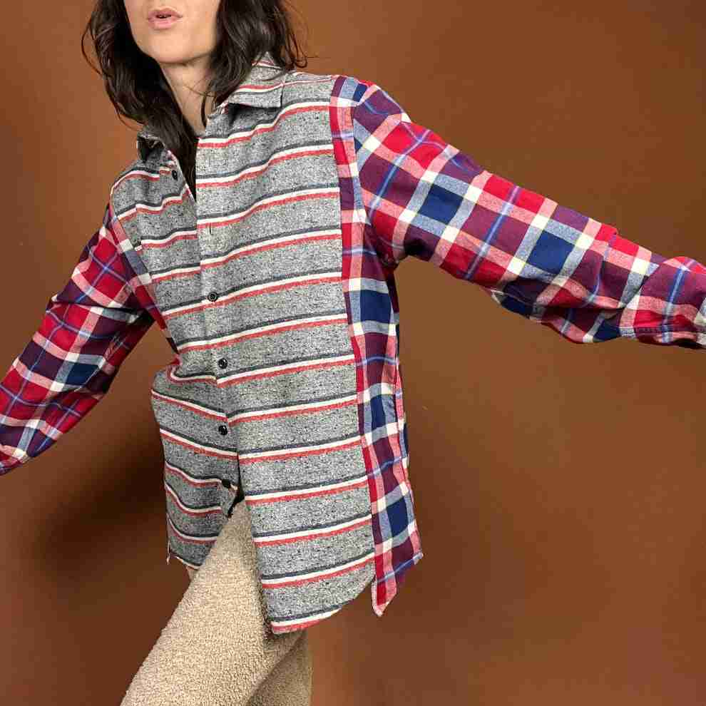a woman in a plaid shirt is posing for a picture.
