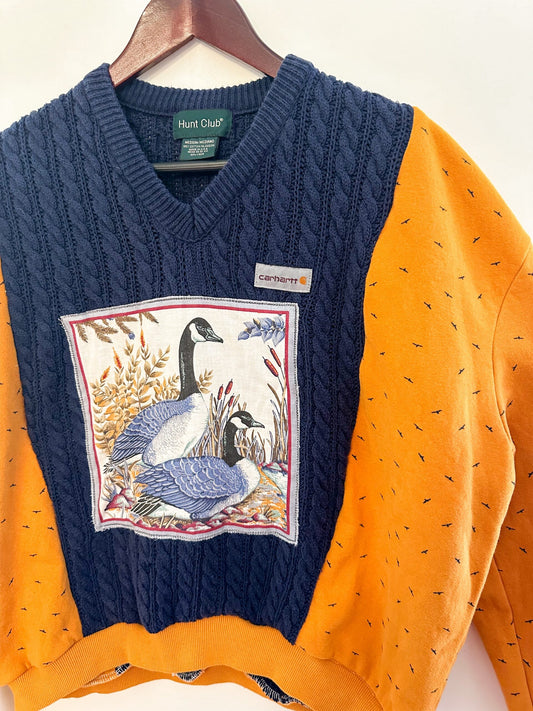 A sweater with an image of geese on it.