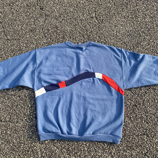 A blue sweatshirt with a red, white and blue stripe.