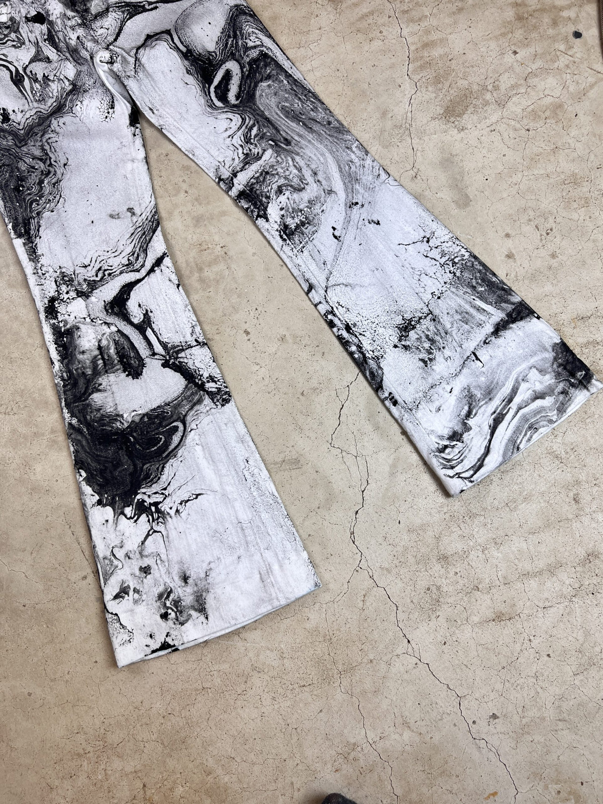 A pair of pants with black and white drawings on them.