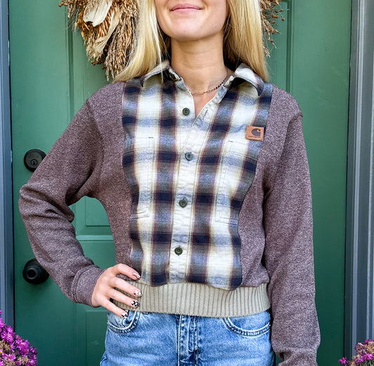 A blonde woman wearing a plaid shirt and jeans.
