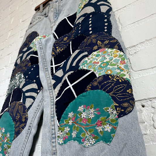 A pair of jeans with patches on them.