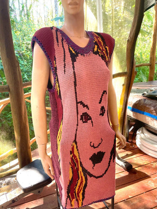 A mannequin wearing a sweater with a woman's face on it.