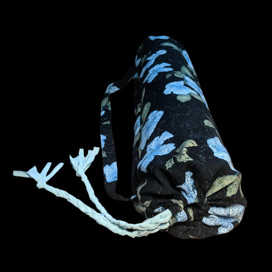 A black yoga mat with blue flowers on it.