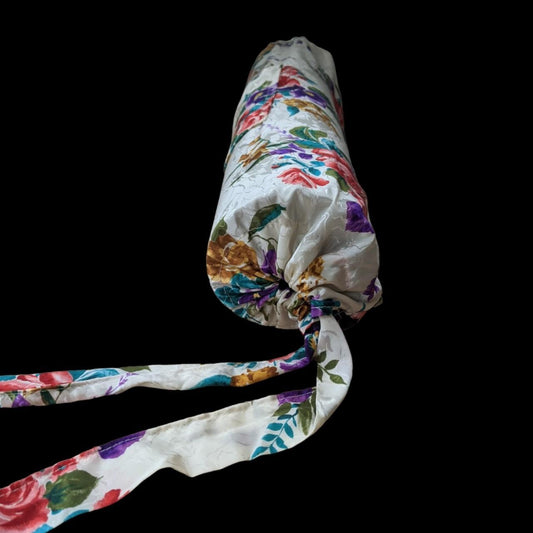 A rolled up towel with a floral pattern on it.