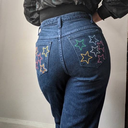 A woman wearing Reworked Embroidered Rainbow Star Pocket Jeans.