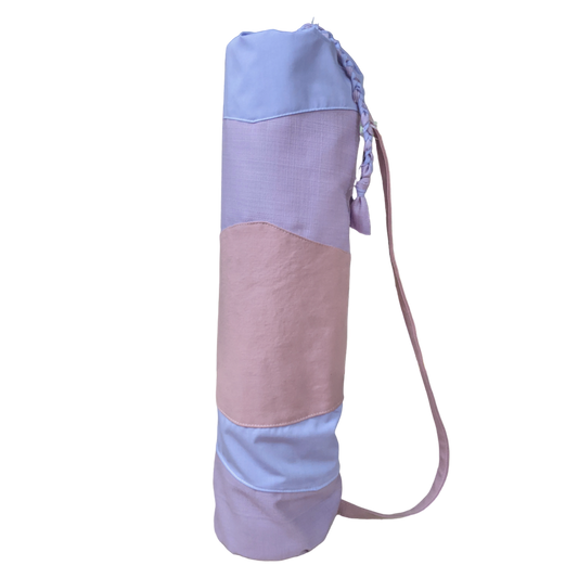 A pink and blue yoga bag with a strap.