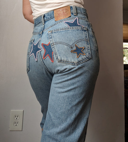 A woman wearing a pair of jeans with stars on them.