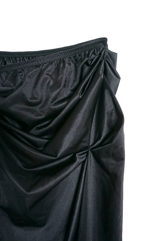 A close up of a LACE ICING Black Mini Skirt on a white background.