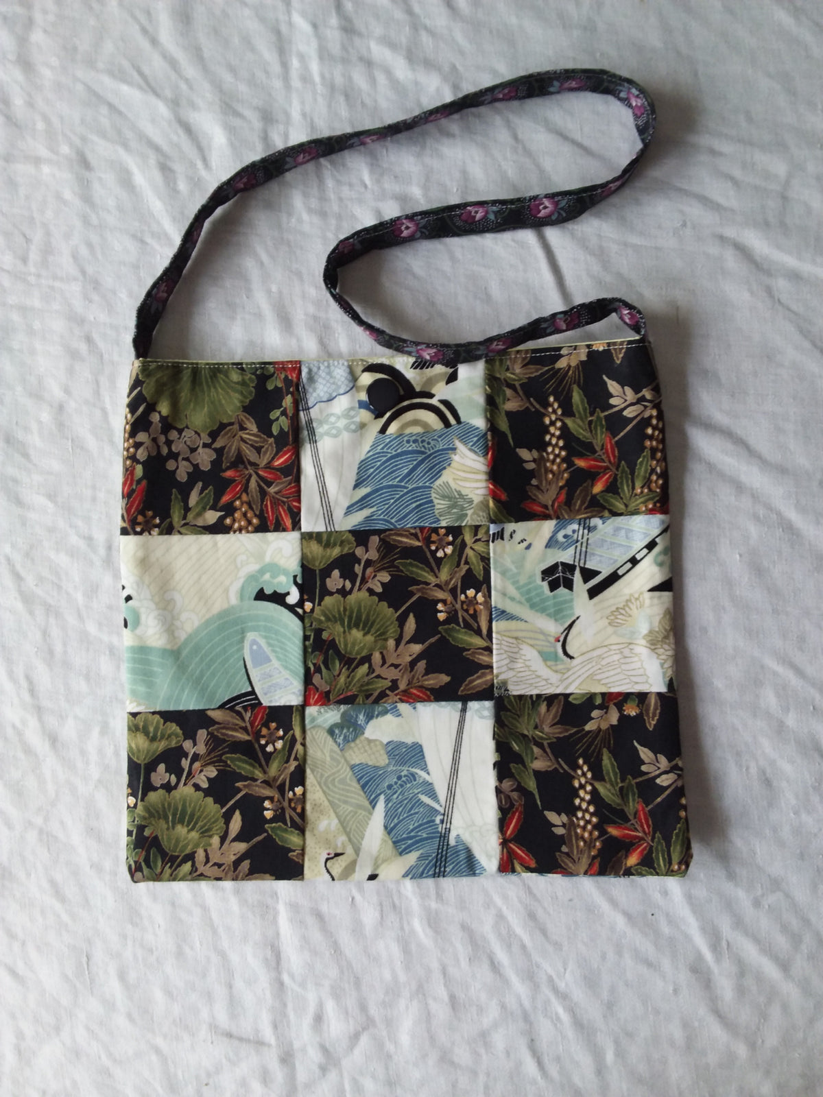 A bag with a patchwork pattern on it.