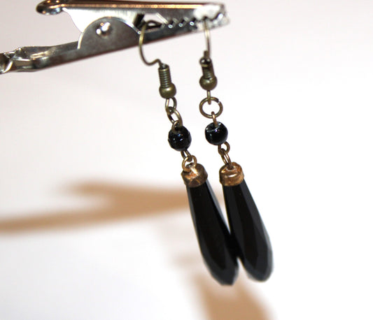 Black jet drop earrings held up to dangle