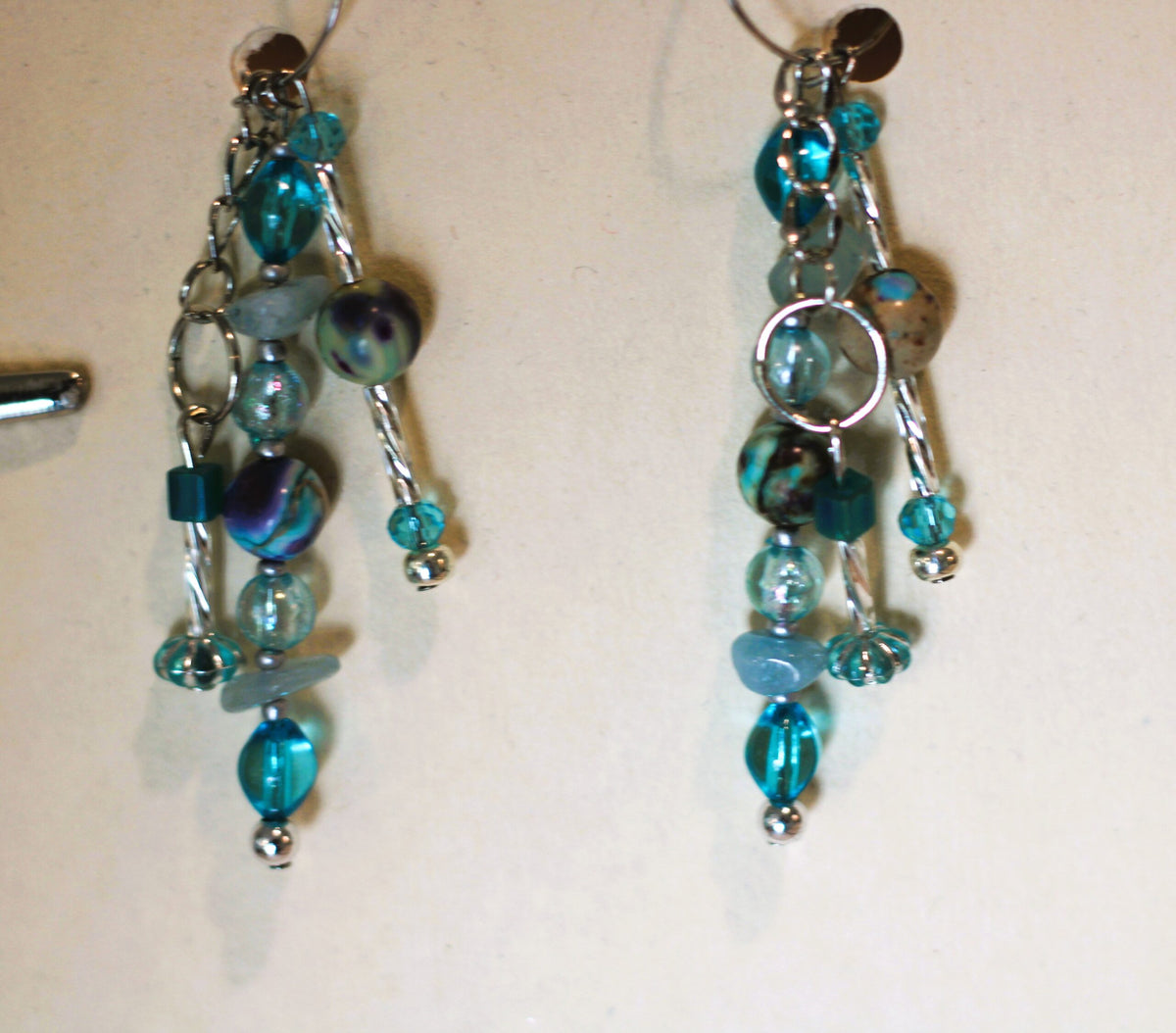 A pair of earrings hanging on a wall.