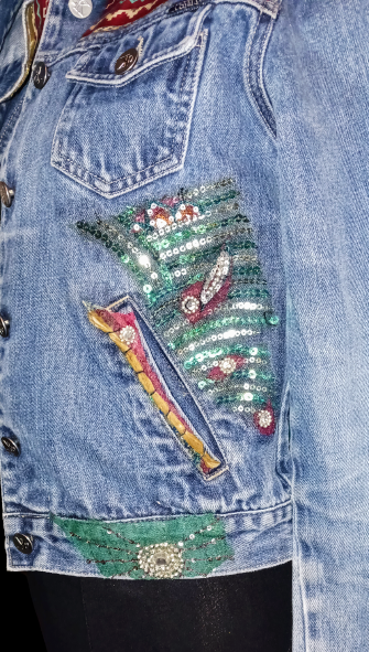A denim jacket with sequins on it.