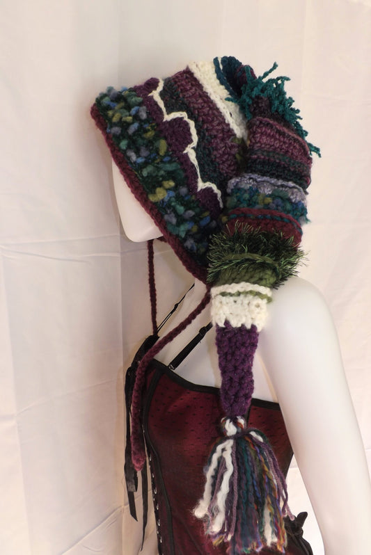 A mannequin wearing a knitted hat with a tassel.