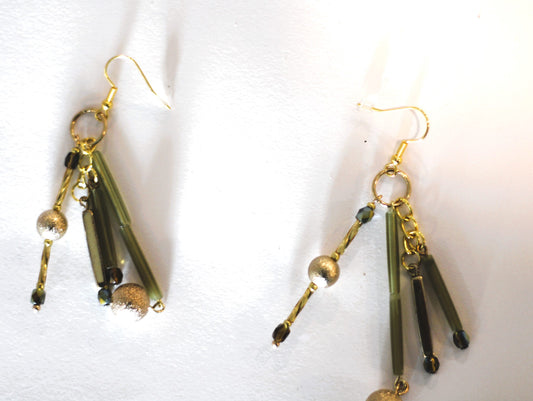 A pair of gold dangling earrings.